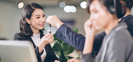 Women handing car keys to each other