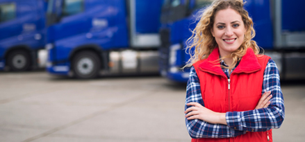  A Mobil distributor smiling and standing in front of trucks