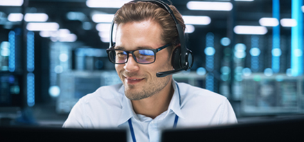 Person sitting at a helpdesk with headset on