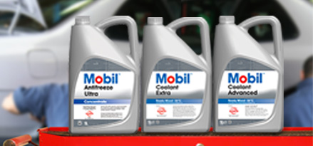 3 Mobil coolants lined up next to each other on a bench