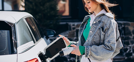 Girl charging an electric car