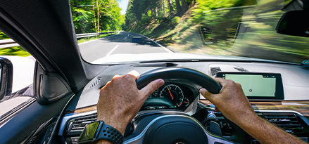 Man driving with hands on wheel