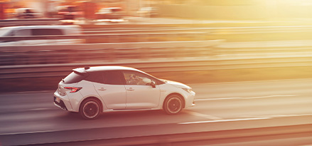 White car driving on a highway