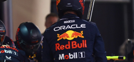 An F1 driver wearing an Oracle Red Bull Mobil 1 racing jacket